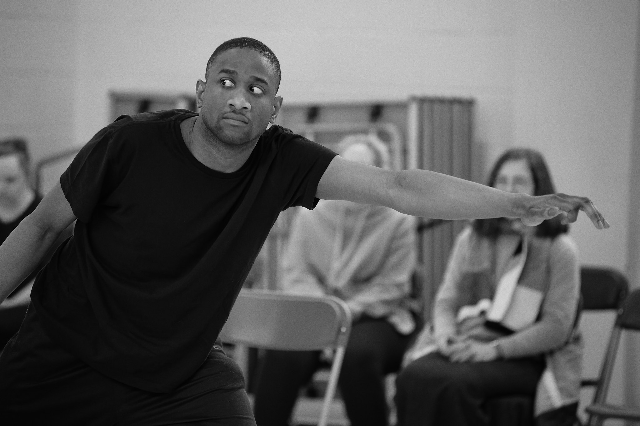 
Black and white photo of Aaron dancing at Professional Development Class sharing 
